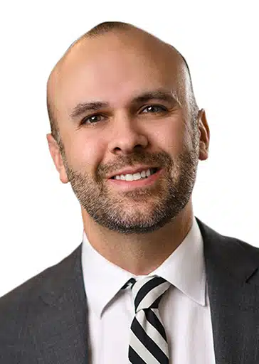 Christopher Kit Crancer SVP, Rad Partnerships and Policy, Executive Director of Quality Institute RAYUS Radiology man in grey suit jacket with black and white tie