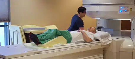 Tech performing High-field MRI on patient