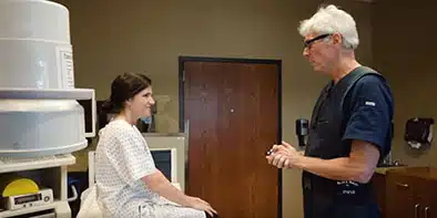 Kurt Schellhas and patient in exam room