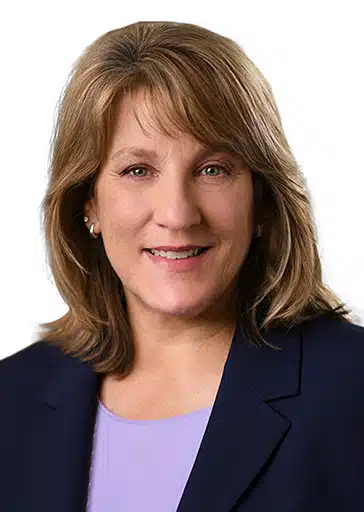 Peggy Reimer woman with brown hair black suit jacket and purple top