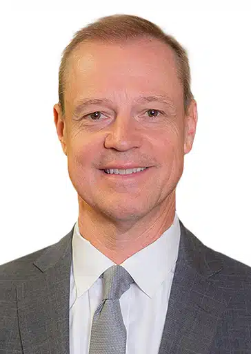 Per Normark General Counsel grey suit jacket and grey tie