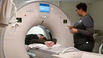 Tech performing Bone Density (QCT) on patient