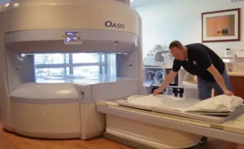 Tech getting Real Open MRI bed ready