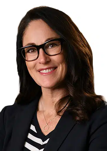 Tiffany Spartz EVP Physician Practices RAYUS Radiology woman with brown hair, glasses, black suit jacket and black and white blouse