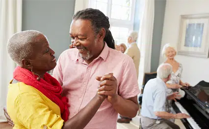 happy couple dancing others playing piano